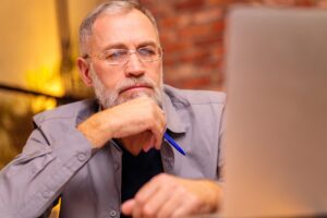 a man looking at a laptop